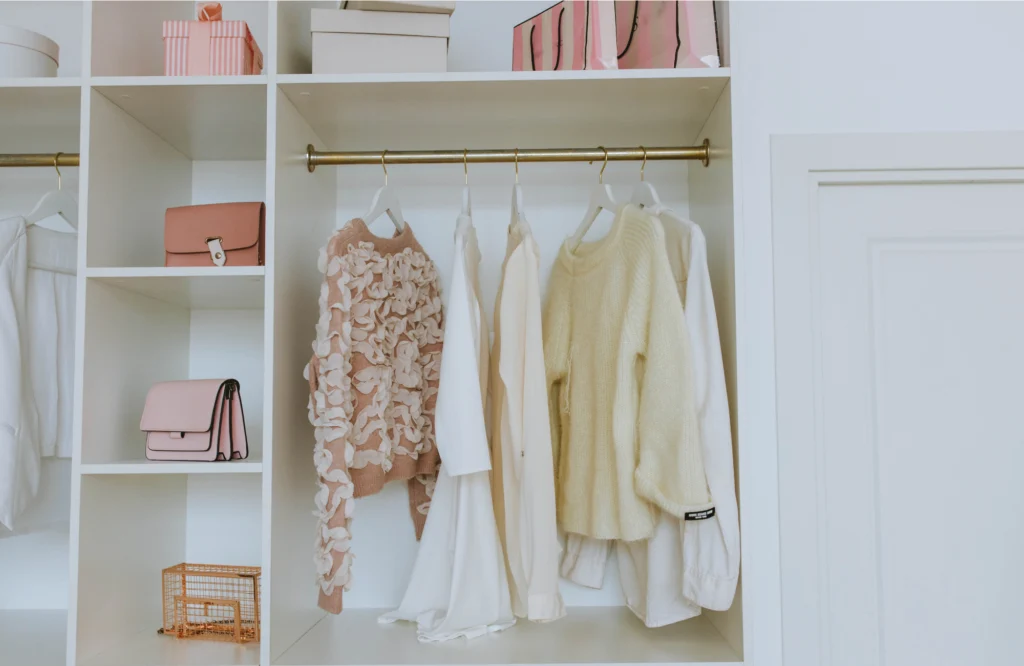Custom closet organization featuring stylish clothing and accessories, emphasizing professional home organizing for remodeling projects.